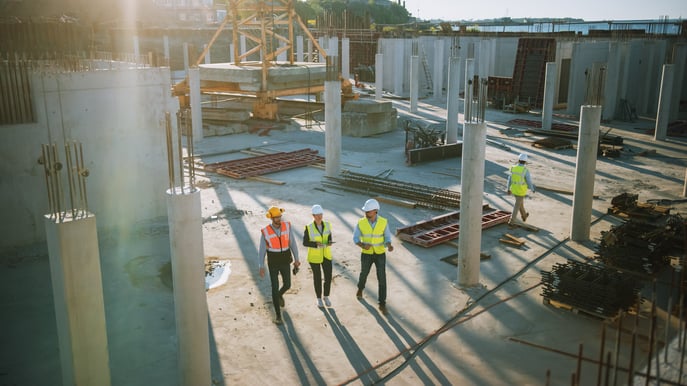 Civil engineers walk through a job site.