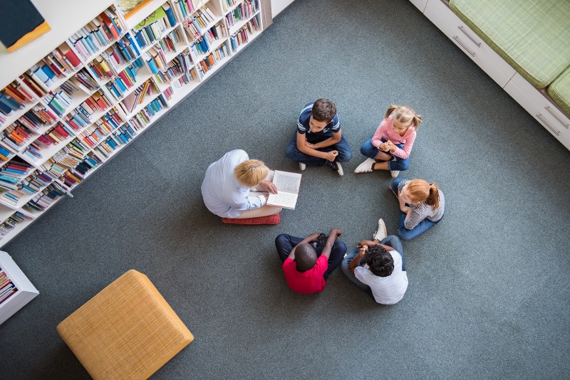 Reading specialist reading to children in a school setting